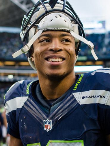 Wide receiver Tyler Lockett of the Seattle Seahawks smiles between